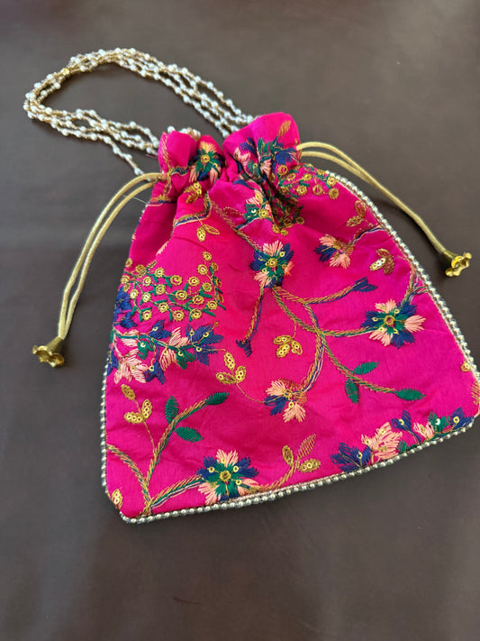 Embroidered silk Potli Bag with a pearl handle & drawstring closure.